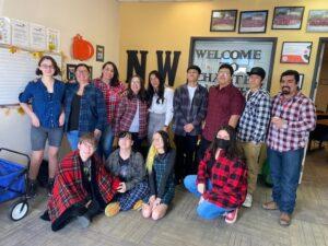 Group photo of students and staff, mostly dressed in flannel