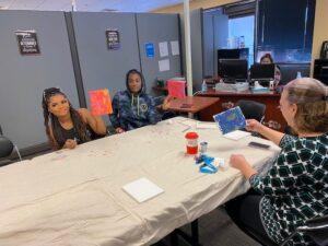 Students creating art at table